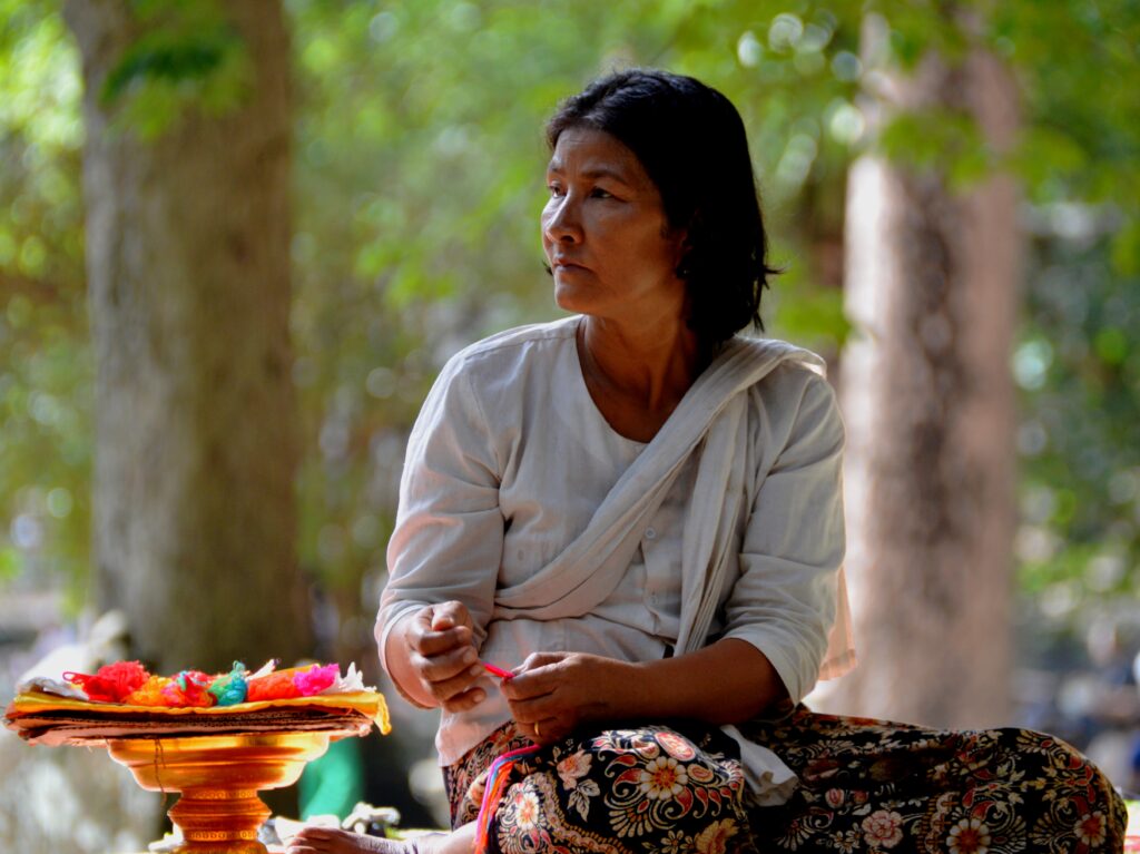 Cambodgienne préparant des offrandes devant un temple